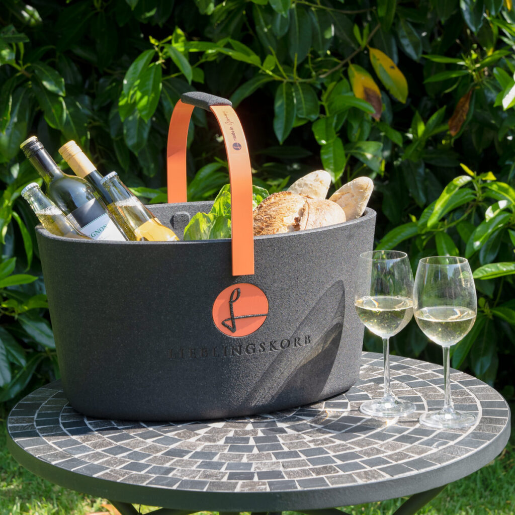 black polypropylene picnic basket with an orange handle.