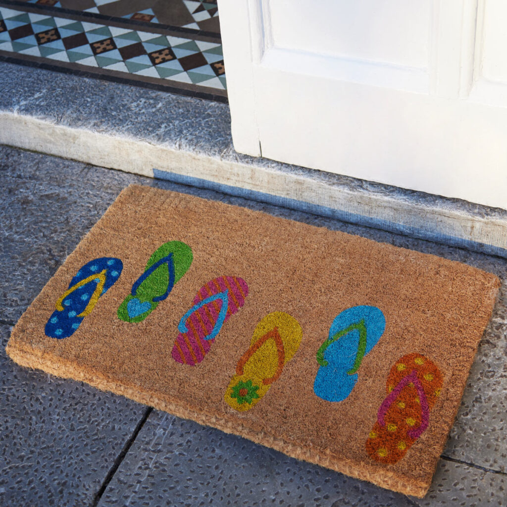 coir door mat with flip flops in pink, blue, green, yellow and orange