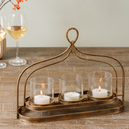 cassidy candle holder made from iron and glass in an antique gold finish